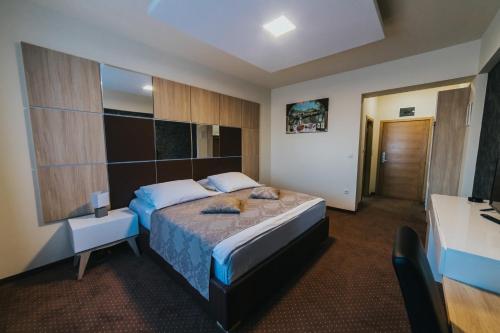 a hotel room with a bed and a bathroom at Hotel Brcko Gas Prijedor in Prijedor