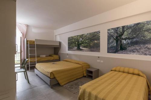 Postel nebo postele na pokoji v ubytování Hotel Ispinigoli