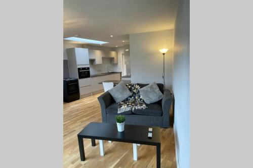 a living room with a couch and a table at Idyllic Self Contained Annex Flat in Eaton in Cringleford