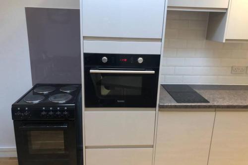 a kitchen with a black oven and a stove at Idyllic Self Contained Annex Flat in Eaton in Cringleford