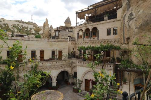 an old building with balconies and plants at Roma Cave Suite in Goreme