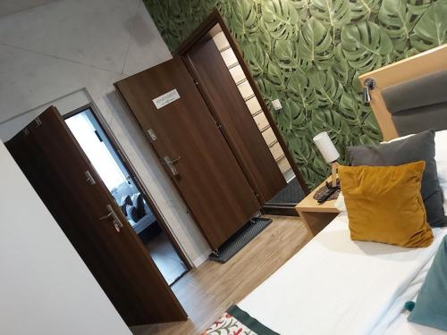 a room with two brown doors and a yellow pillow at Dworek Zakopane in Zakopane