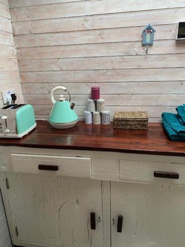 a counter with a tea kettle on top of it at The Old Garage in Saltdean