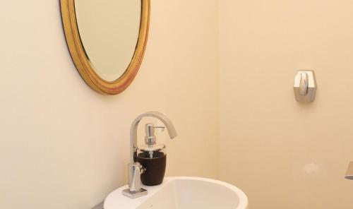 a bathroom with a sink and a mirror at Leblon House I in Rio de Janeiro