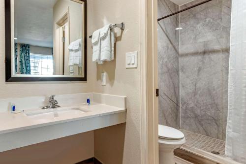 a bathroom with a sink and a toilet and a shower at Rodeway Inn in Caldwell