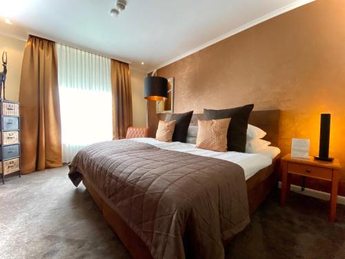 a hotel room with a large bed and a window at Parkhotel Bielefeld in Bielefeld