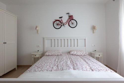 a bedroom with a bed with a bike on the wall at APARTMANI Mirona - Tučepi in Tučepi