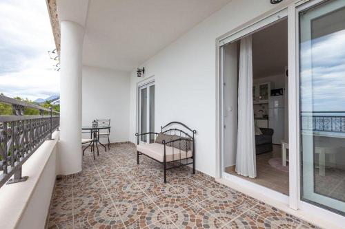 a room with a balcony with a bed and a table at APARTMANI Mirona - Tučepi in Tučepi