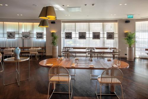a restaurant with a large table and chairs at Radisson Blu Hotel Istanbul Ottomare in Istanbul