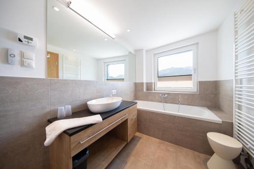 a bathroom with a sink and a bath tub at A Casa Elements in Serfaus