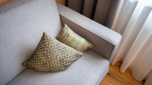 a couch with two pillows on it at A Casa Elements in Serfaus