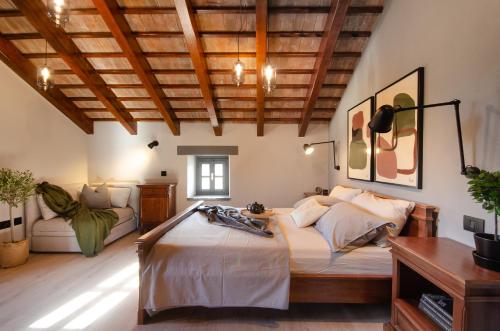 a bedroom with a large bed in a room with wooden ceilings at Villa Zonti in Rovinjsko Selo