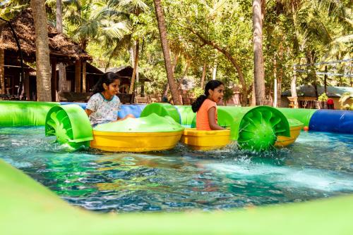 two women are riding on an inflatable ride in the water at GoGo Land Resort & Adventurous Sports in Pūvār