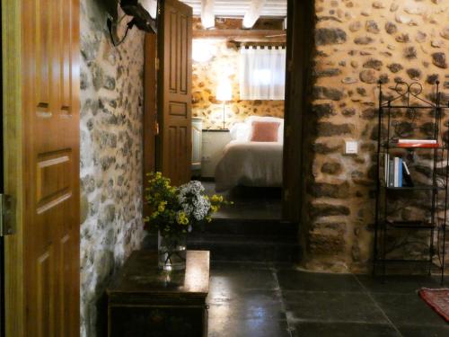 a hallway with a bedroom and a bed in a room at Casa Anamaria Hotel in Ollers