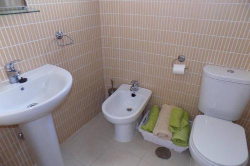 a bathroom with a white toilet and a sink at The Town House - Mojacar in Mojácar