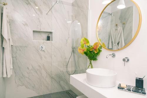 a bathroom with a sink and a mirror at The Vista Rooms & Terrace in Rome