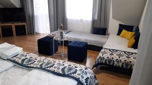 a living room with two beds and a table at Dworek Zakopane in Zakopane