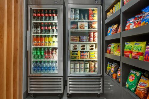 a refrigerator filled with lots of drinks and food at Holiday Inn Express & Suites Merced - Yosemite Natl Pk Area by IHG in Merced