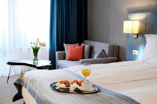 a hotel room with a tray of food on a bed at SPA Resort St Ivan Rilski - Halfboard & All Inclusive in Bansko