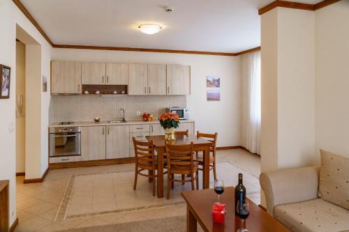 a kitchen and dining room with a table and chairs at SPA Resort St Ivan Rilski - Halfboard & All Inclusive in Bansko