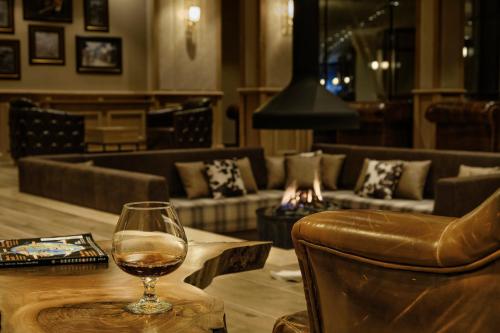 a glass of wine sitting on a table in a restaurant at SPA Resort St Ivan Rilski - Halfboard & All Inclusive in Bansko