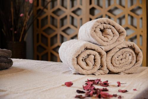 a pile of towels sitting on top of a bed at SPA Resort St Ivan Rilski - Halfboard & All Inclusive in Bansko