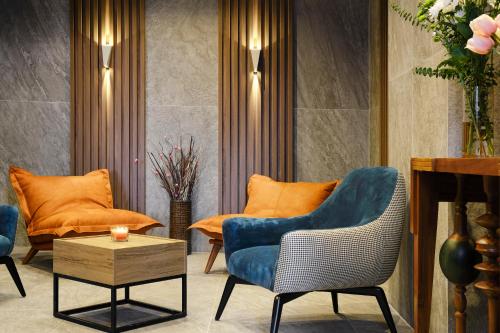 a living room with two chairs and a table at SPA Resort St Ivan Rilski - Halfboard & All Inclusive in Bansko