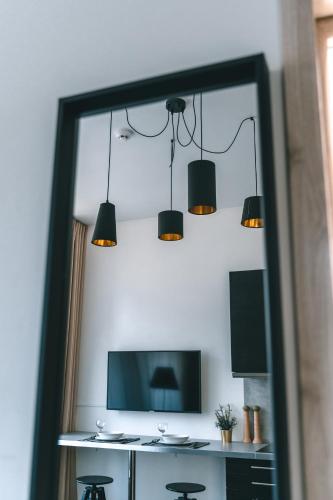 a room with a table with chairs and lights at Brother House Kaunas in Kaunas