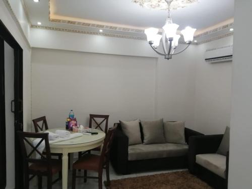 a living room with a couch and a table at Saraya Eltram-families only in Alexandria