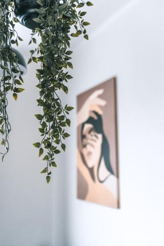 a picture of a woman on a wall with ivy at Brother House Kaunas in Kaunas