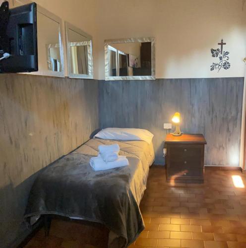 a bedroom with a bed with towels on it at ALBERGO 900Strati in Bergamo