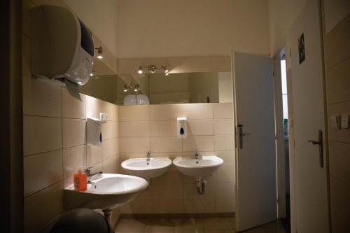 a bathroom with two sinks and a mirror at Onefam Home in Prague