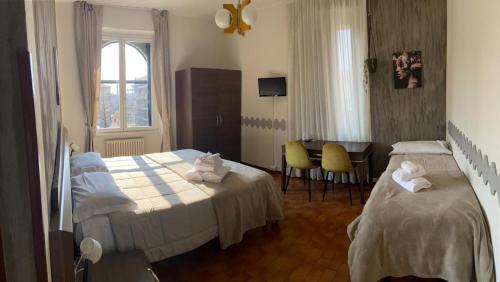 En eller flere senge i et værelse på ALBERGO 900Strati