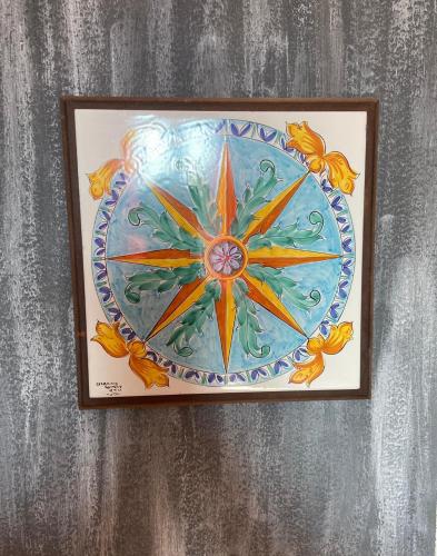 a picture of a colorful painting on a wall at ALBERGO 900Strati in Bergamo