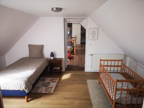a bedroom with a bed and a stairway at LE DOMAINE DE COAT ROGAN L'espace familial in Ploëzal