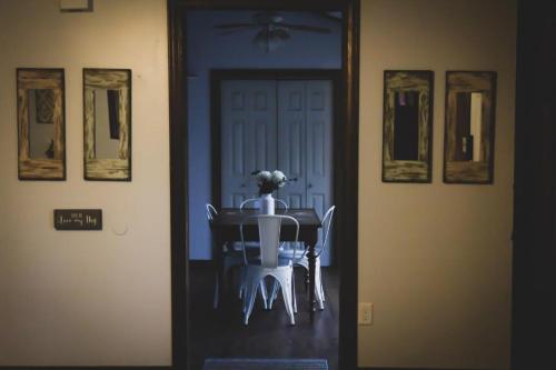 a dining room table with a flower on top of it at Avenwood Cabins in Logan