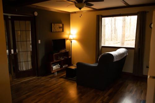 a living room with a couch and a window at Avenwood Cabins in Logan