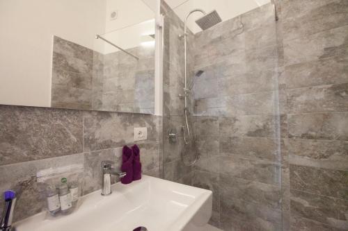a bathroom with a sink and a shower at Myrtus Guest House Cagliari in Cagliari