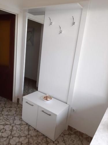 a room with a white cabinet and a mirror at Apartment Summer Dreams in Kaštela