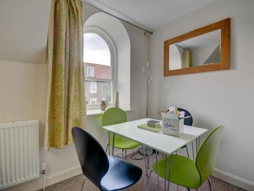 a room with a table and chairs and a window at The Old Auction Rooms Lot 2 Central with Private Parking in Whitby