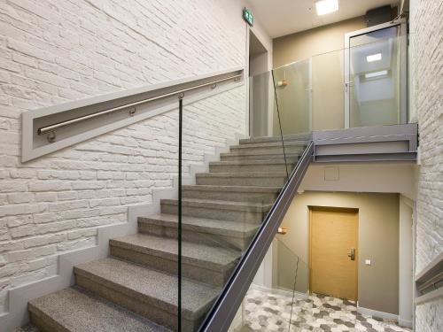 a staircase in a building with a brick wall at Riverside Aparthotel Cracow in Kraków