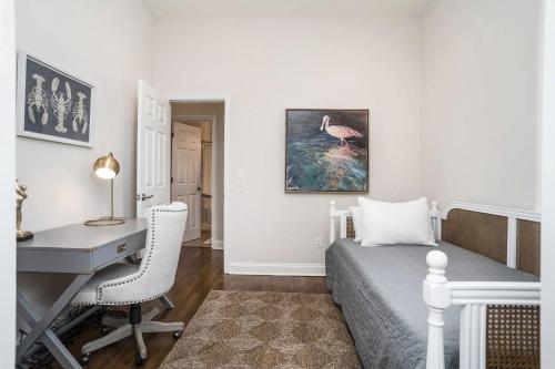 a bedroom with a desk and a bed with a desk chair at Fairway to Heaven in Fripp Island