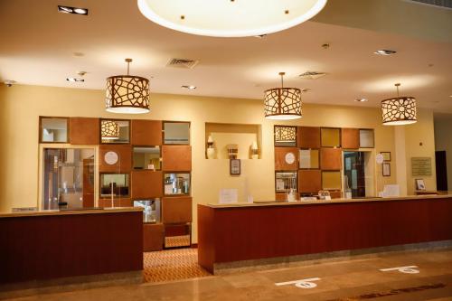 a lobby with two pendant lights and a counter at Crowne Plaza Sohar by IHG in Sohar