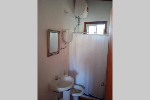 a bathroom with a sink and a toilet at • Cabaña Las Hortensias • in La Pedrera