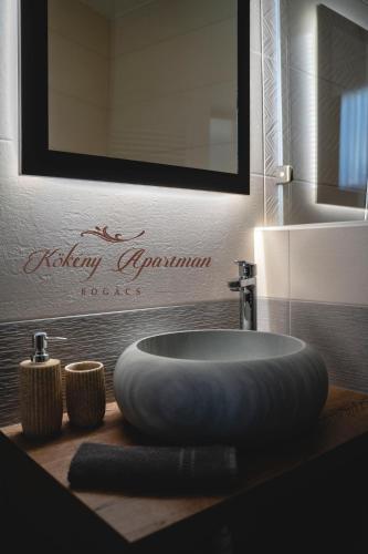 a bathroom with a round sink on a counter at Kökény Apartman Bogács in Bogács