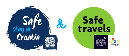 two stickers with the words safe travels and stay in croatia at Apartman Zagreb Maksimir in Zagreb