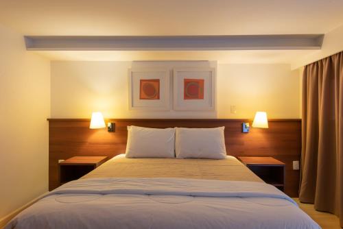 Tempat tidur dalam kamar di Hotel Habitare
