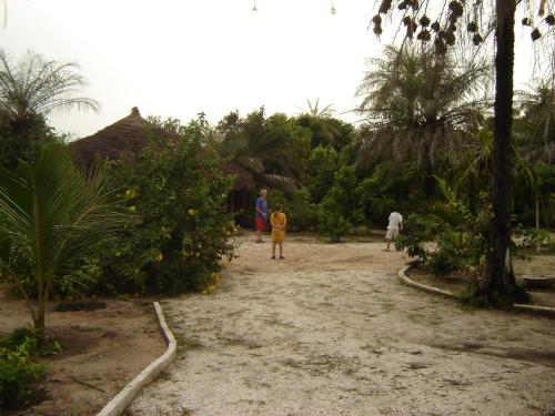 a group of people standing on a dirt road at Kansala Ta Toto in Kafountine
