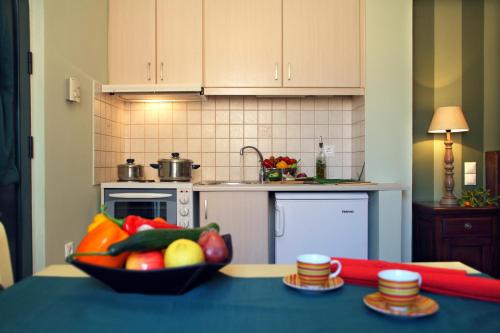 a bowl of fruit on a table in a kitchen at Anthias Garden in Lefkada Town
