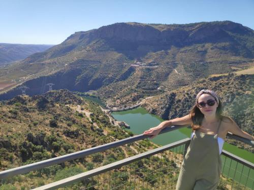 a woman standing on top of a balcony overlooking a valley at Hotel rural Rinconada de las Arribes in Aldeadávila de la Ribera